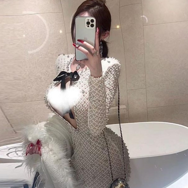 French light luxury celebrity daughter gold bow heavy industry pearl hip wrap long-sleeved dress pure desire hollow temperament short skirt