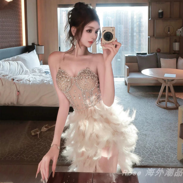 Elegant white swan-inspired feather skirt dress - slimming, rhinestone embellished mini dress for vacation, runway, party, and evening events